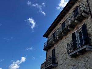 a building with balconies and a blue sky at I Ninni in Castiglione del Lago