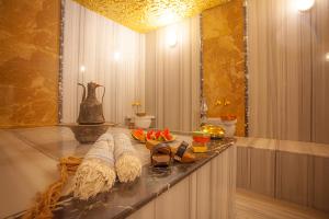 a bathroom with a counter with shoes on it at Old Town Point Hotel & Spa Antalya in Antalya