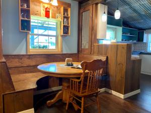 a kitchen with a wooden table and a wooden chair at Bunkhouse Farm Stay in Fort White