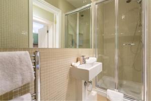 a bathroom with a sink and a shower at Spectacular 2 Bedroom Apartment with Sunny Garden & Terrace in Dublin