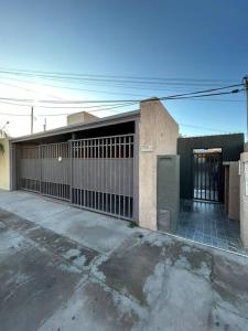 a building with a gate in a parking lot at Departamento en San Juan in San Juan