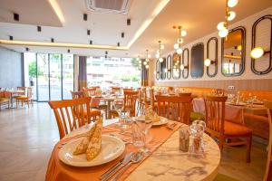 a restaurant with a long table with plates and glasses at Old Town Point Hotel & Spa Antalya in Antalya