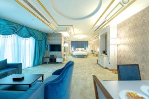 فندق دبليو اي في جدة: غرفة معيشة مع أريكة زرقاء وغرفة نوم