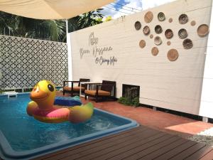 a pool with a rubber duck in a swimming pool at Baan Wassana In The City Old Moat in Chiang Mai