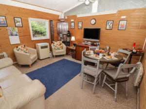 a living room with a couch and a table at Awelon in Newcastle Emlyn