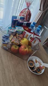 a table with a container of food and a bowl of snacks at Red Luxury Apartment Lake On in Mamaia
