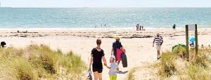 a group of people walking on the beach at Domaine de la Tranquillité R in Noyal-Muzillac