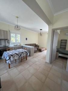 a kitchen and a living room with a table in it at Karfas Seascape in Chios