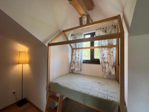a room with a bunk bed with a window at Deleni Retreat - Casa Sitaru in Deleni