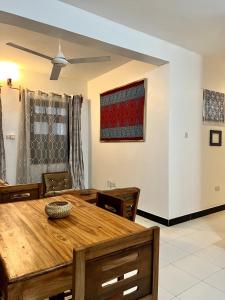 a dining room with a wooden table and chairs at Serene Abodes in Stone Town