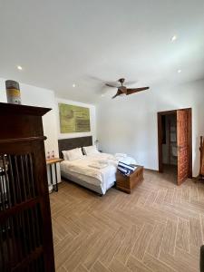 a bedroom with a bed and a ceiling fan at El Amparo in Alhama de Granada
