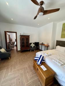 a bedroom with a bed and a ceiling fan at El Amparo in Alhama de Granada