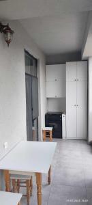 eine Küche mit einem weißen Tisch im Zimmer in der Unterkunft Green house - Apartment 1g - 17 in Rustawi