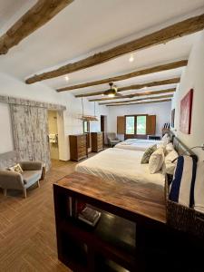 a bedroom with a large bed and a living room at El Amparo in Alhama de Granada