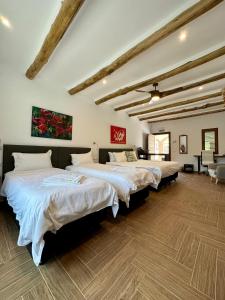 a bedroom with three beds in a room at El Amparo in Alhama de Granada