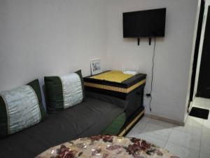 uma sala de estar com um sofá e uma televisão de ecrã plano em Apartment in the center of marrakech for a good price em Marrakech