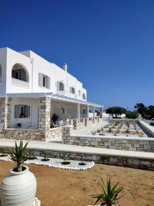 a large white building with some plants in front of it at Sea and Salt Naxos 3 in Kastraki