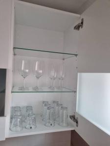 a row of wine glasses sitting on a shelf at ~Ferienwohnung Sandhausen / HD~ in Sandhausen