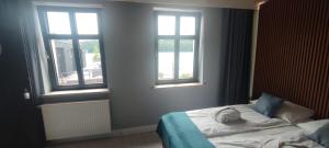 a bedroom with a bed with a stuffed animal on it at Kurort Kameralny in Mikołajki