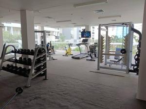 a gym with lots of equipment in a building at Campus Convenience at Scientia Apartment in Tangerang