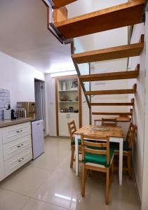a kitchen and dining room with a table and chairs at Tony Guesthouse in Acre