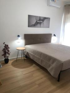 a bedroom with a bed and a table in it at Mediterranea Apartment in Trapani