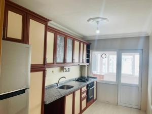 a kitchen with a sink and a refrigerator at Beautiful Apartment for rent in Beylikduzu