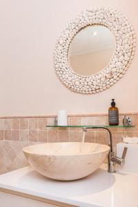 a bathroom with a large bowl sink and a mirror at Sunny Vacation Villa No 11 in Bridgetown