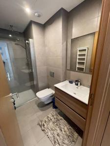 a bathroom with a sink and a toilet and a shower at Superbe Appartement sécurisé avec un balcon in Casablanca
