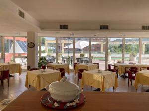 a restaurant with tables and chairs and a pot on a table at Europalace Hotel Todi in Todi