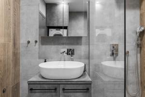 a bathroom with a large white sink and a shower at Jim & Jo House in Thessaloniki