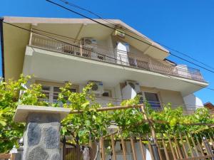 a large white building with a balcony and trees at Guest rooms Rusalka in Kranevo