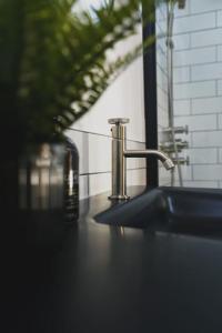 a bathroom sink with a faucet on a counter at The Cow Shed - Rural Barn Conversion in Little Bytham