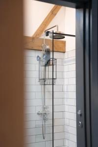 a shower in the corner of a bathroom at The Cow Shed - Rural Barn Conversion in Little Bytham