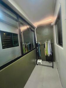 eine ebenerdige Dusche in einem Zimmer mit Kleidung in der Unterkunft Oppas Studio Unit near Sm uptown in Cagayan de Oro