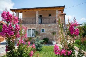 a house with pink flowers in front of it at Villa Bali Serenity in Stolac