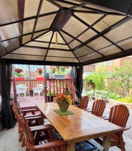 a wooden table and chairs on a patio at All Seasons Bed & Breakfast in Mississauga