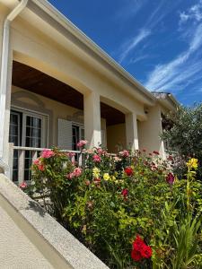 a house with flowers in front of it at Panoias Country House in Vila Real
