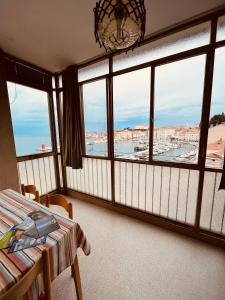 a room with a bed and a view of a harbor at Piran with a view in Piran