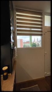 a window in a kitchen with a window blind at Good Knight Apartman in Szeged