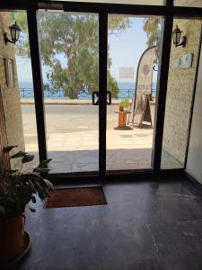 an open door with a view of the ocean at By the oceam luxury studios in Piraeus