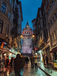 a group of people walking down a city street at night at Hotel Gritti Pera & Spa in Istanbul