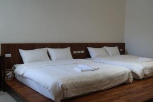 Postel nebo postele na pokoji v ubytování SUNME Inn
