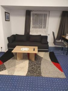 a living room with a couch and a coffee table at ST2 Apartment in Triberg
