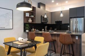 a kitchen with a table and chairs and a counter at Summit Place - Condo With Mountain Views in Revelstoke