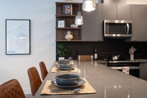 a kitchen with a table with bowls and plates on it at Summit Place - Condo With Mountain Views in Revelstoke