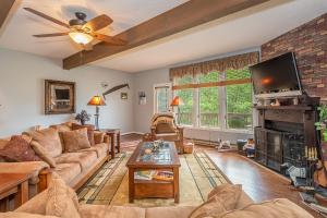 a living room with a couch and a tv at Beary Relaxing in McHenry