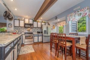 a kitchen with a table and chairs and a refrigerator at Beary Relaxing in McHenry