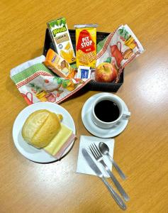 a tray of breakfast food and a cup of coffee at Hotel Portal do Éden in Sorocaba
