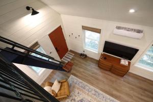 a large living room with a flat screen tv at Secluded Treehouse in the Woods - Tree Hugger Hideaway in Branson